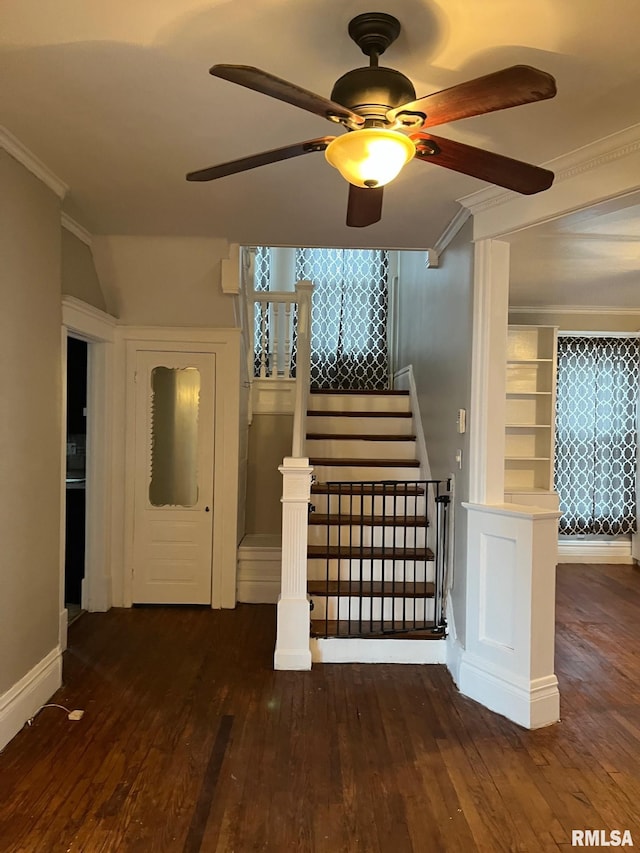 stairway featuring hardwood / wood-style floors, ceiling fan, and ornamental molding