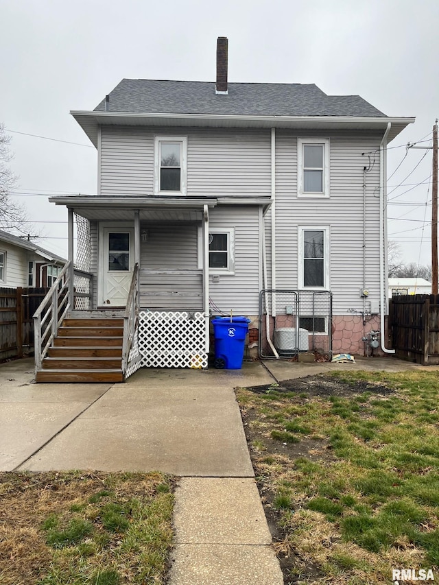 rear view of house with a yard