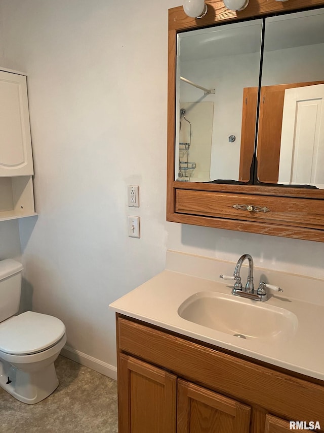 bathroom featuring a shower, vanity, and toilet