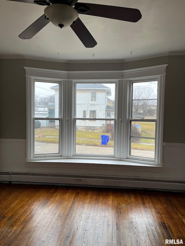 empty room featuring ceiling fan, dark hardwood / wood-style flooring, and ornamental molding