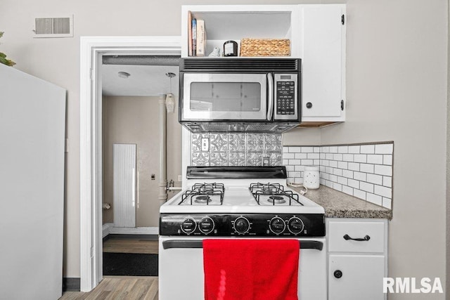 kitchen featuring light hardwood / wood-style floors, white cabinetry, white appliances, and tasteful backsplash