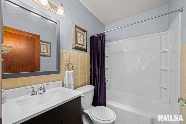 full bathroom featuring vanity, toilet, shower / bath combo with shower curtain, and tile walls