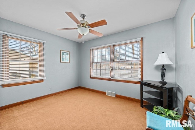 interior space with light carpet and ceiling fan