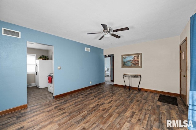 spare room featuring ceiling fan and dark hardwood / wood-style floors