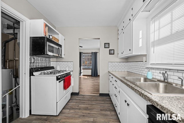 kitchen with white gas range, white cabinetry, sink, water heater, and dark hardwood / wood-style flooring