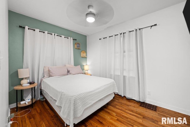 bedroom featuring ceiling fan and dark wood-type flooring