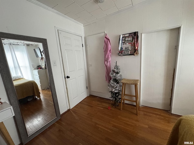 hallway featuring dark hardwood / wood-style floors and crown molding