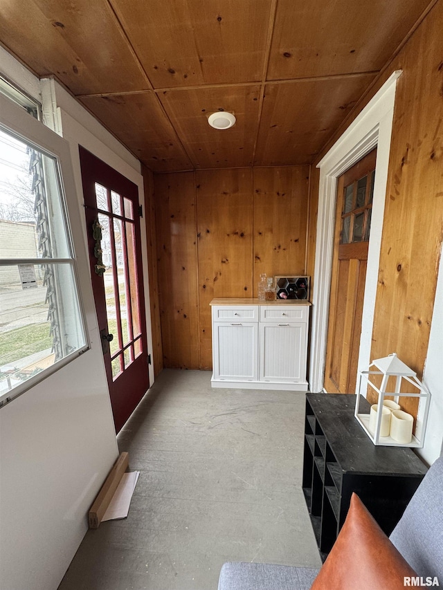 entryway with wooden walls and wooden ceiling