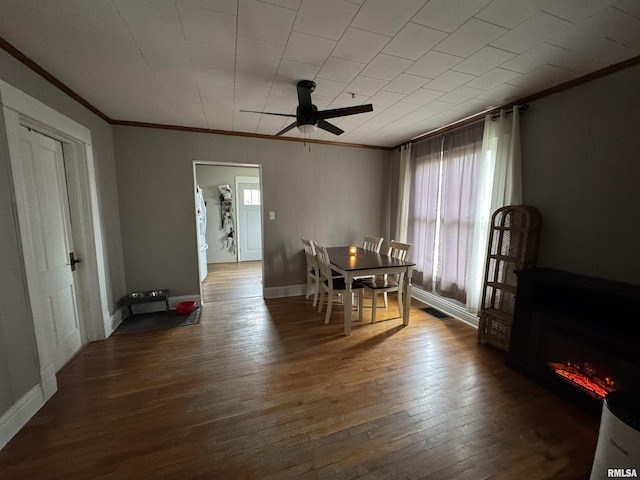 dining room with hardwood / wood-style flooring, ceiling fan, and crown molding