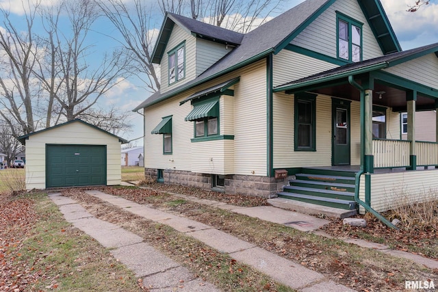 view of property exterior featuring an outbuilding, a garage, and covered porch