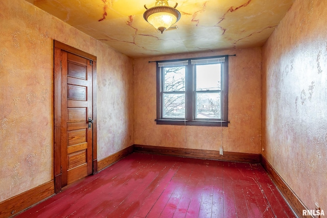 empty room with dark wood-type flooring