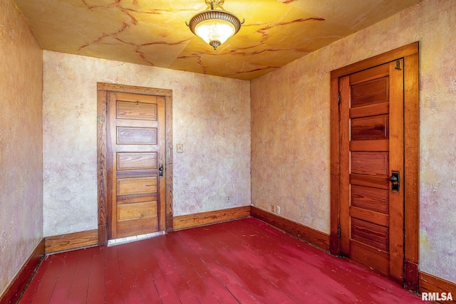 empty room with hardwood / wood-style floors