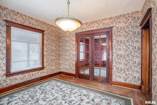 unfurnished room featuring dark hardwood / wood-style flooring and french doors