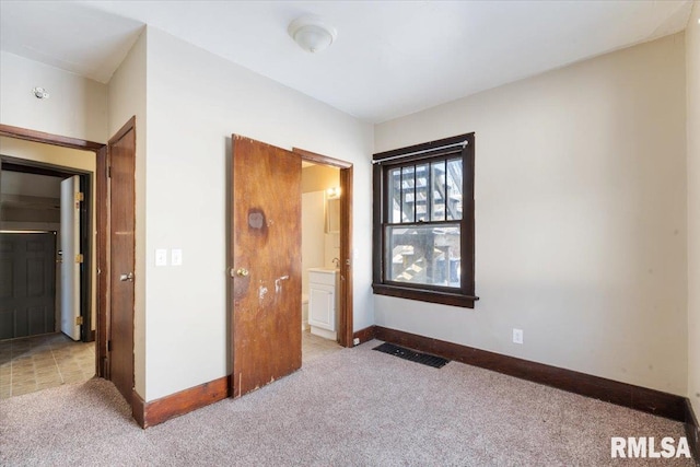 unfurnished bedroom featuring light colored carpet