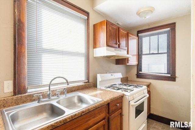 kitchen featuring white range with gas stovetop and sink