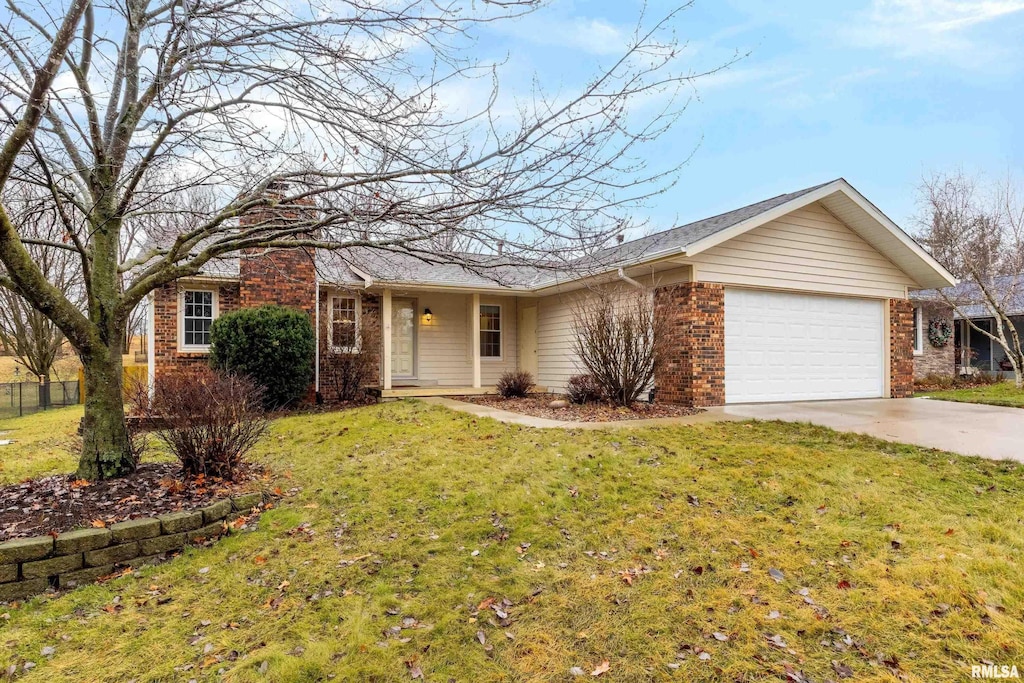 ranch-style home with a garage and a front yard