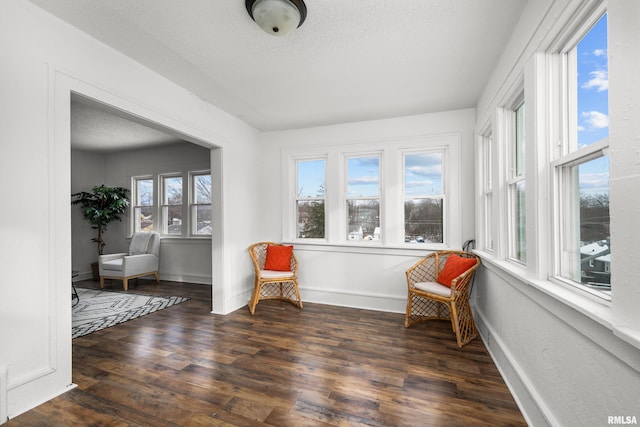 sitting room with dark wood-type flooring and a textured ceiling