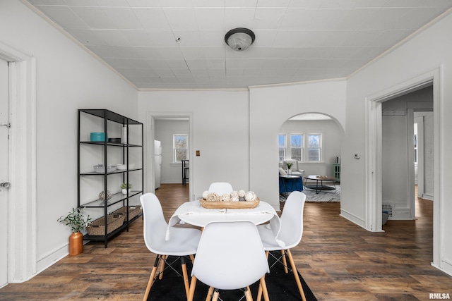 dining room featuring dark hardwood / wood-style floors and crown molding