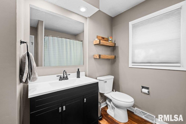 bathroom featuring hardwood / wood-style floors, vanity, and toilet