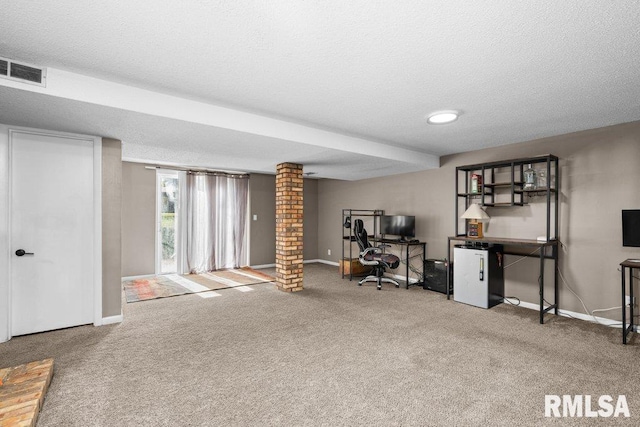 basement featuring carpet, a textured ceiling, and fridge