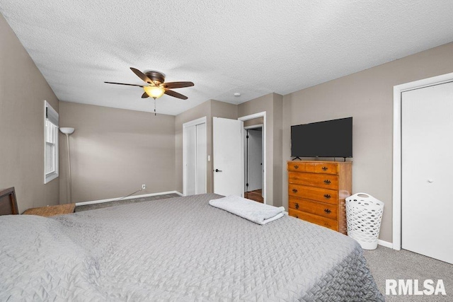 bedroom with carpet, a textured ceiling, and ceiling fan