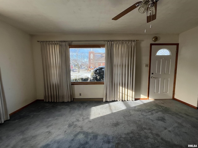 carpeted foyer featuring ceiling fan