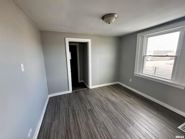 empty room featuring dark wood-type flooring