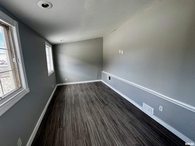 empty room with dark wood-type flooring