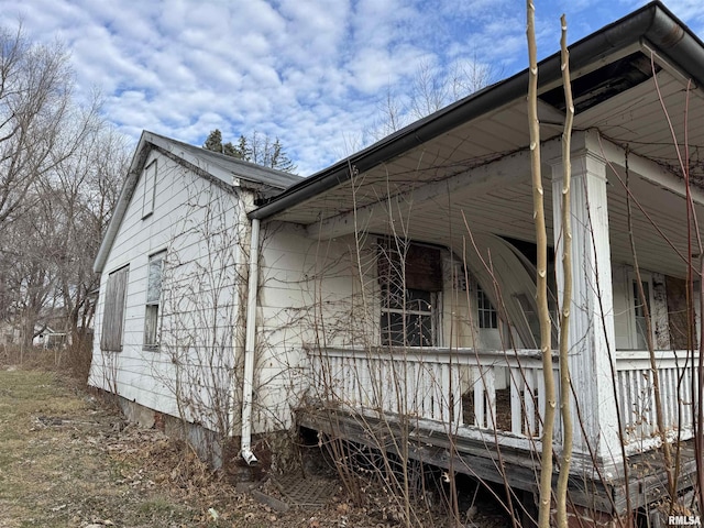 view of side of home with covered porch