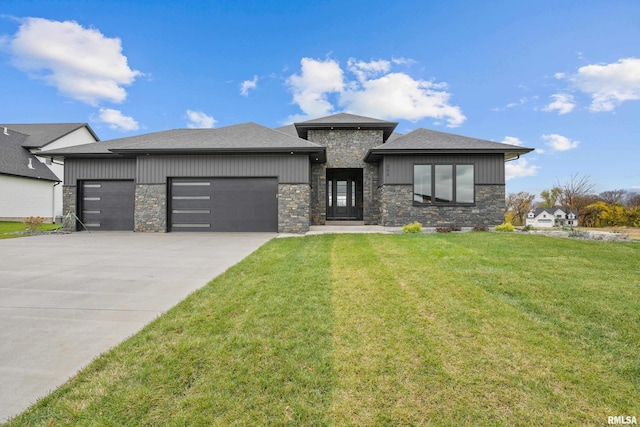 view of front of property with a front yard and a garage