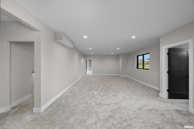 basement featuring light carpet