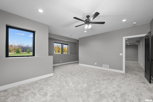 unfurnished room with ceiling fan and light colored carpet