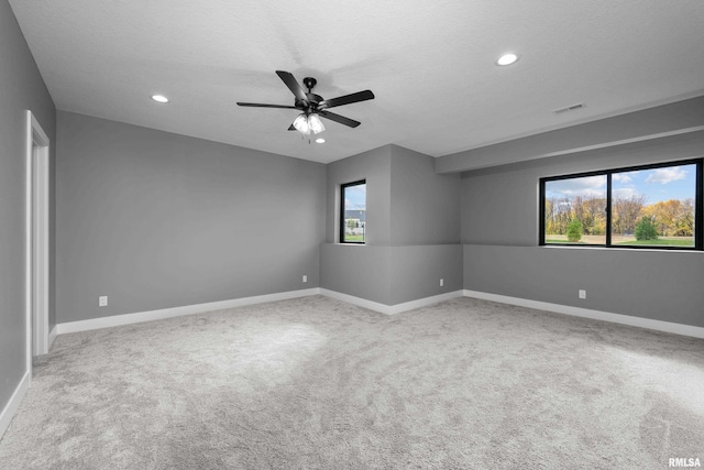 unfurnished room with carpet, a textured ceiling, and ceiling fan