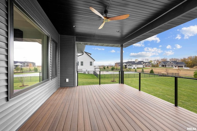 wooden terrace with a lawn and ceiling fan