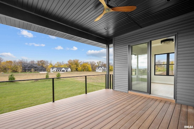 wooden deck featuring a yard and ceiling fan