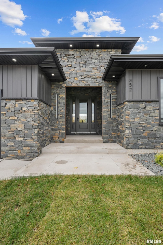 doorway to property featuring a yard