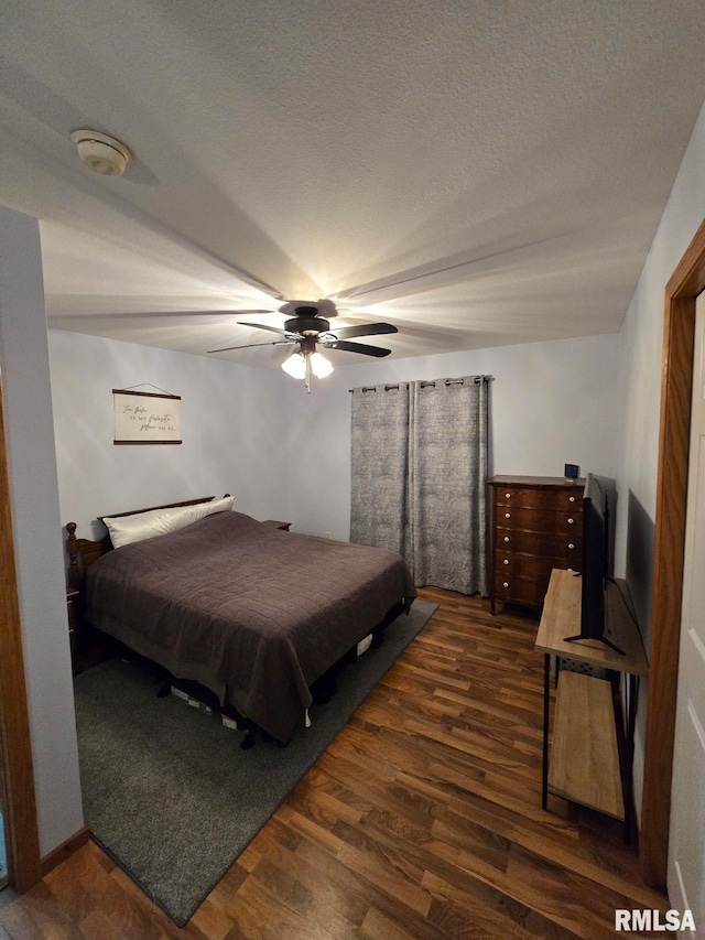 bedroom featuring dark hardwood / wood-style floors and ceiling fan