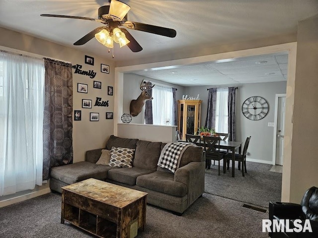 living room with ceiling fan and carpet