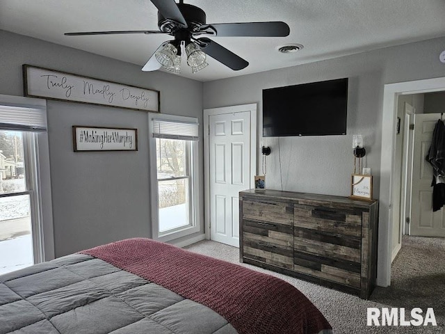 carpeted bedroom with ceiling fan