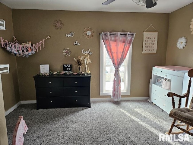 living area featuring carpet and ceiling fan