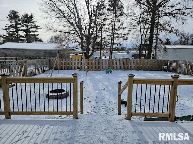 snow covered deck featuring an outdoor fire pit