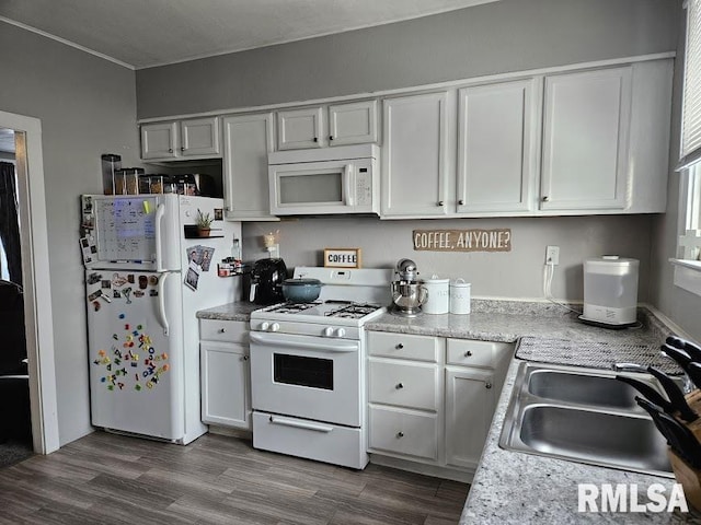 kitchen featuring white cabinets, dark hardwood / wood-style flooring, white appliances, and sink