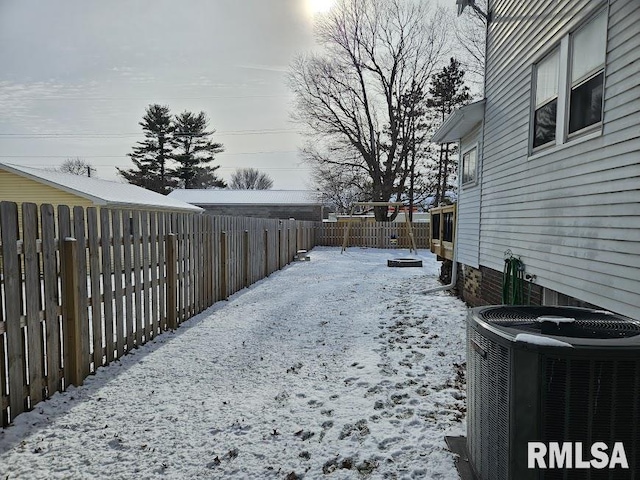 yard covered in snow featuring central air condition unit