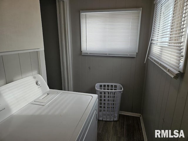 clothes washing area featuring dark hardwood / wood-style floors and washing machine and clothes dryer