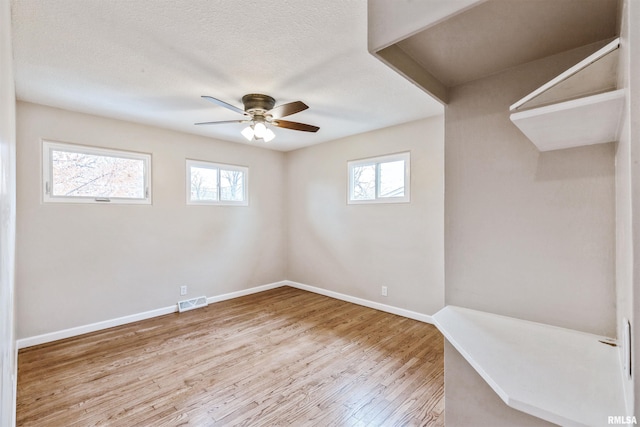 empty room with light hardwood / wood-style floors and ceiling fan