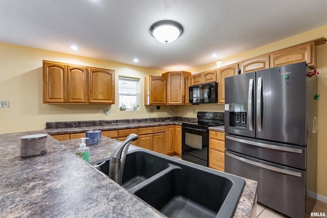 kitchen with light tile patterned flooring, sink, and black appliances