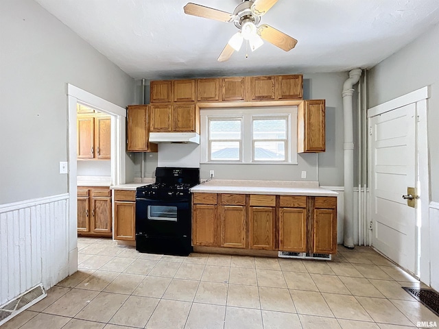 kitchen with black gas range, light tile patterned flooring, and ceiling fan