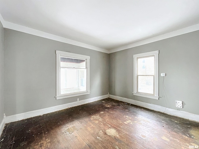 spare room with dark hardwood / wood-style floors and ornamental molding