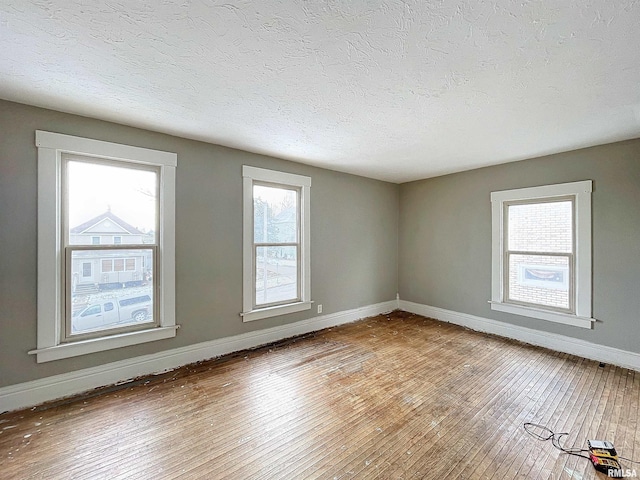 unfurnished room with wood-type flooring