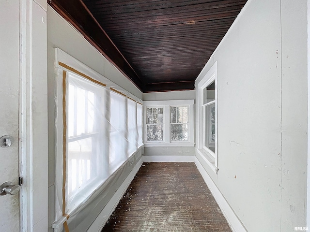 unfurnished sunroom with plenty of natural light and wooden ceiling